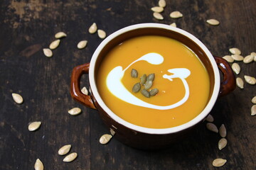 Pumpkin cream soup in a stoneware dish