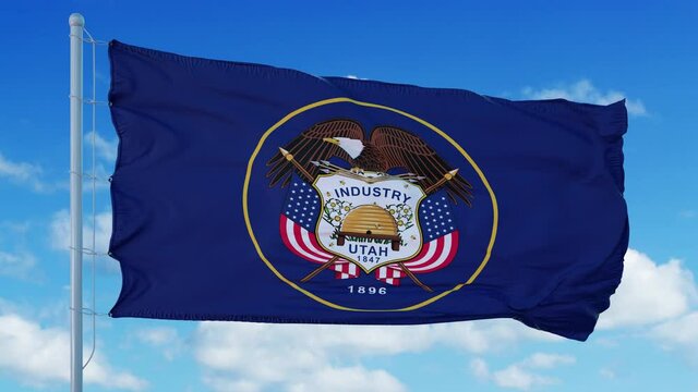 Utah flag on a flagpole waving in the wind, blue sky background. 4K