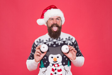 xmas shopping time. tree decoration. happy man in santa hat. new year party fun. celebrate winter holidays. merry christmas. man in sweater hold decorative snowballs. Everyone will get a present