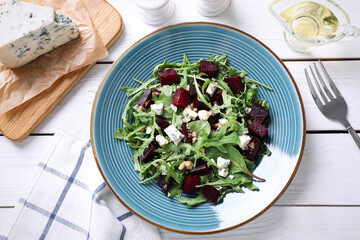 Fresh delicious beet salad on white wooden table, flat lay