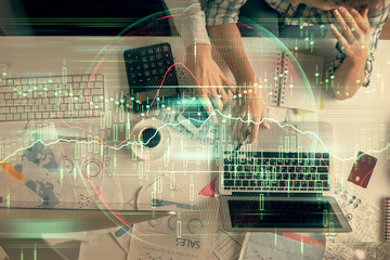 Double exposure of man and woman working together and financial graph hologram drawing. market analysis concept. Computer background. Top View.