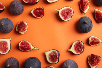 Delicious ripe figs on orange background, flat lay. Space for text