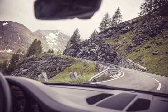 Mountain pass seen through windshield of moving car