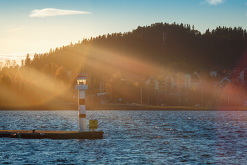 A solar flare illuminates the water lantern at the Ostersund marina - 388146807