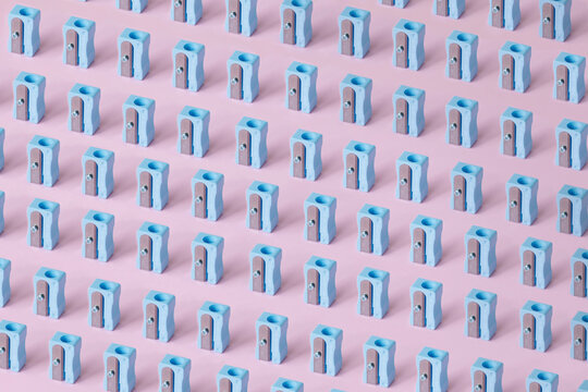 Pattern of blue erasers against pink background