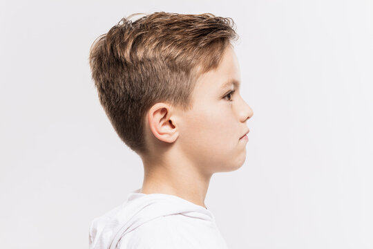 Close-up of cute thoughtful boy looking away against white background