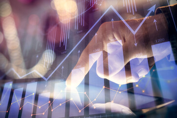 Multi exposure of man's hands holding and using a phone and financial chart drawing. Market analysis concept.