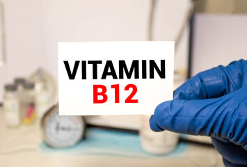Doctor holding a card with Vitamin B12, medical concept