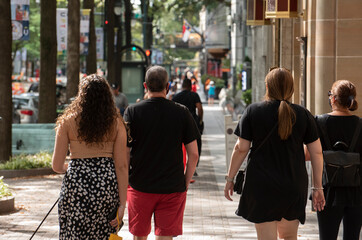 A family strolls through downtown together. 