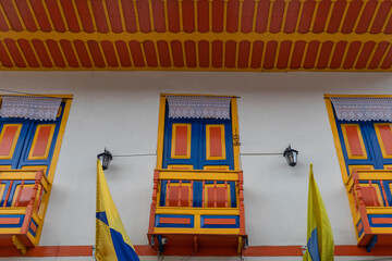Balconies and windows of red, blue, green, yellow colors in the coffee region in Colombia.