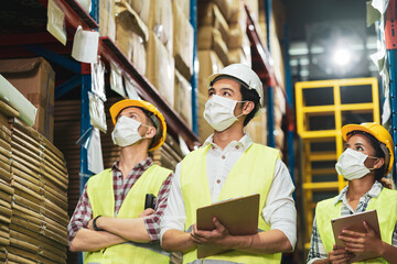 Multi ethnic worker wear face mask as new normal work in warehouse