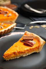 Slice of delicious homemade pumpkin pie on plate, closeup