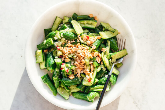 smashed cucumber salad in marble bowl