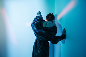 Cyberpunk woman standing under red illumination