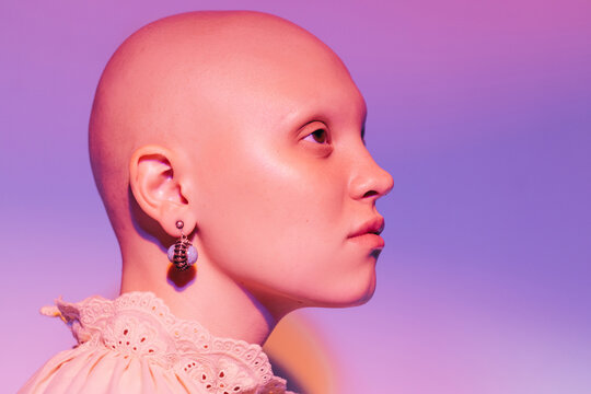 Vintage styled hairless woman with earrings