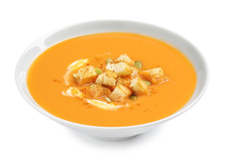 Tasty creamy pumpkin soup with croutons and seeds in bowl on white background