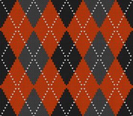 Knitted argyle Halloween pattern. Wool knitinng. Scottish plaid in orange, black and grey rhombuses. Traditional  Scottish background of diamonds . Seamless fabric texture. Vector illustration