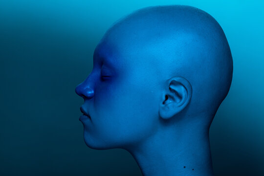 Bald model under blue light