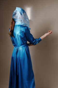 Stylish woman suffocating under plastic bag