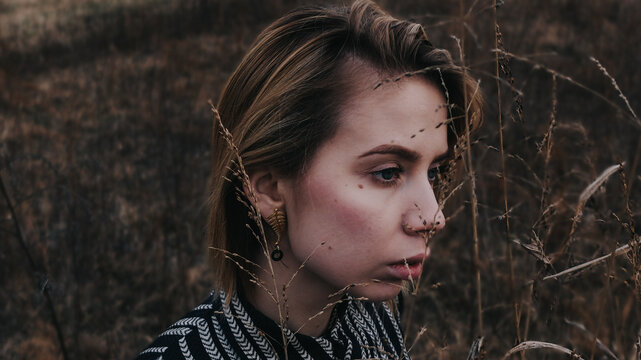 A beautiful portrait of a young blond woman in the field