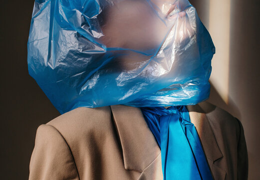 Anonymous woman with blue bag on head