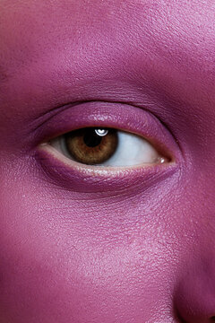 Crop person with painted face looking at camera