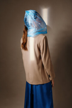 Anonymous woman with blue bag on head