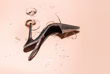 High heeled shoe and broken glass after party