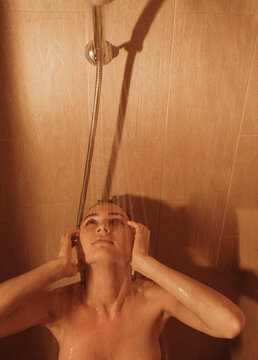 Young woman taking hot shower