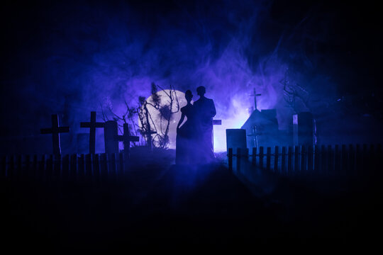 Horror Halloween concept. Scary zombie bride on a night cemetery.