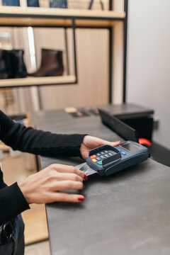 Woman paying with credit card in shop