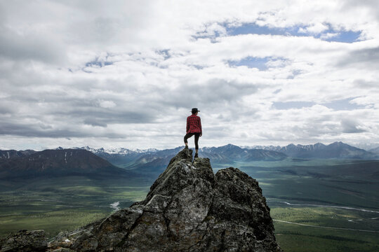 Adventurous Woman Standing on Rock