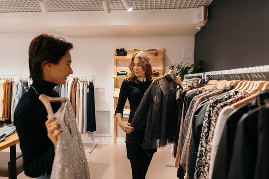 Women choosing outfit in fashion boutique