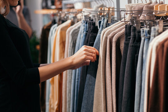 Young Woman In A Vintage Shop Looking For The Right Dress
