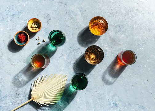 tea in coloured drinking glass with palm leaf