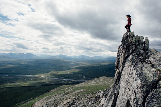 Adventurous Woman Standing on Rock