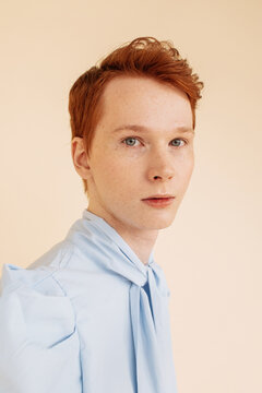 Ginger male posing on beige background