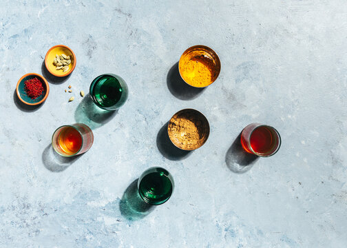 colourful glasses of chair tea with spices, light and shadow