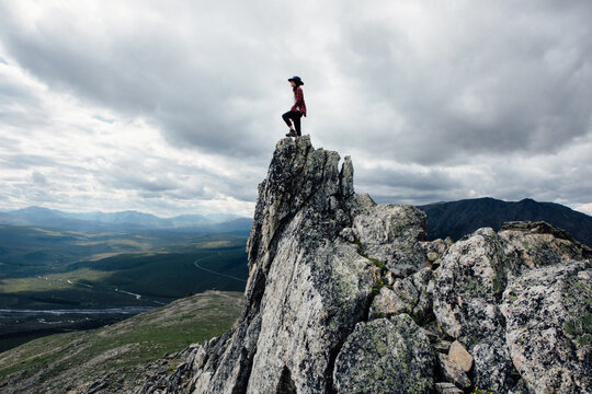 Adventurous Woman Standing on Rock