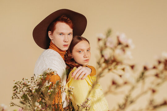 Young couple with retro outfits with flowers
