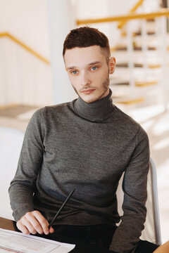Thoughtful male designer looking away