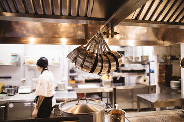 Professional utensil and chef in kitchen