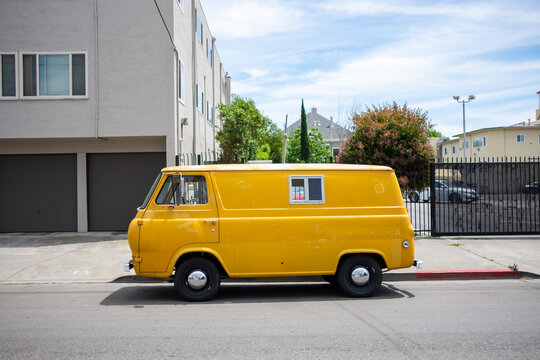 An older yellow van parked on the street