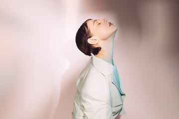 Graceful stylish woman with closed eyes tilting head back