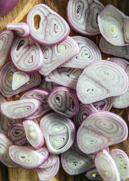 Sliced Purple Shallots On Wood Cutting Board