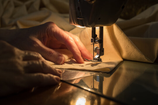 Woman working with sewing machine at home