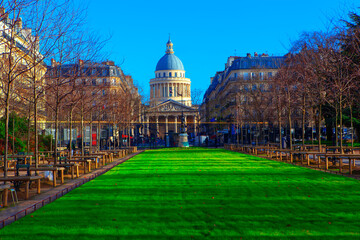 Fototapeta na wymiar View of Pantheon cupola in Paris . Urban park with fresh lawn . France capital city scenery with Pantheon 