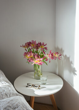 Bed side table with flowers in a vase