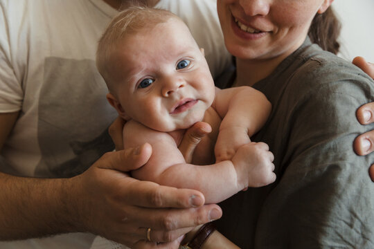 Baby in the arms of parents