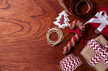 Fototapeta na wymiar .Christmas composition on wooden background with ribbons and gifts.Top view. Copy space